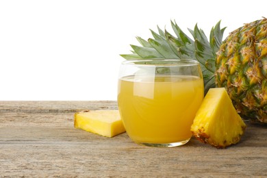 Photo of Tasty pineapple juice in glass and fresh fruit on wooden table against white background. Space for text