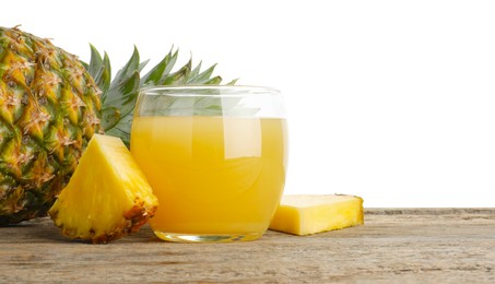 Photo of Tasty pineapple juice in glass and fresh fruit on wooden table against white background. Space for text