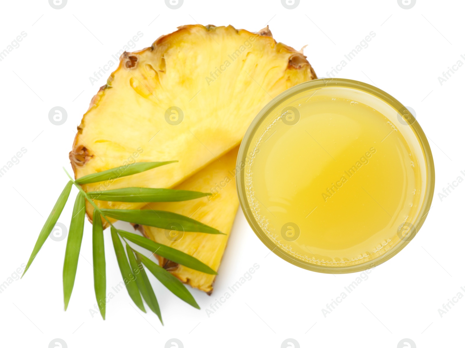 Photo of Tasty pineapple juice in glass, leaf and slices of fresh fruit isolated on white, top view