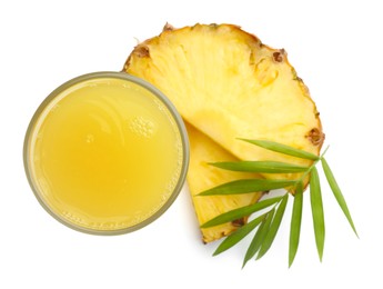 Photo of Tasty pineapple juice in glass, leaf and slices of fresh fruit isolated on white, top view