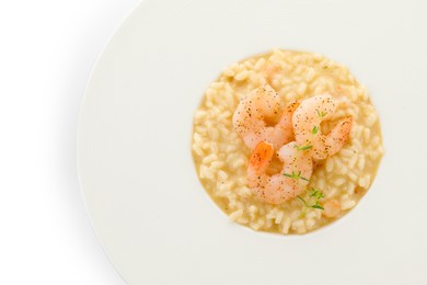 Photo of Delicious risotto with shrimps and cheese isolated on white, top view