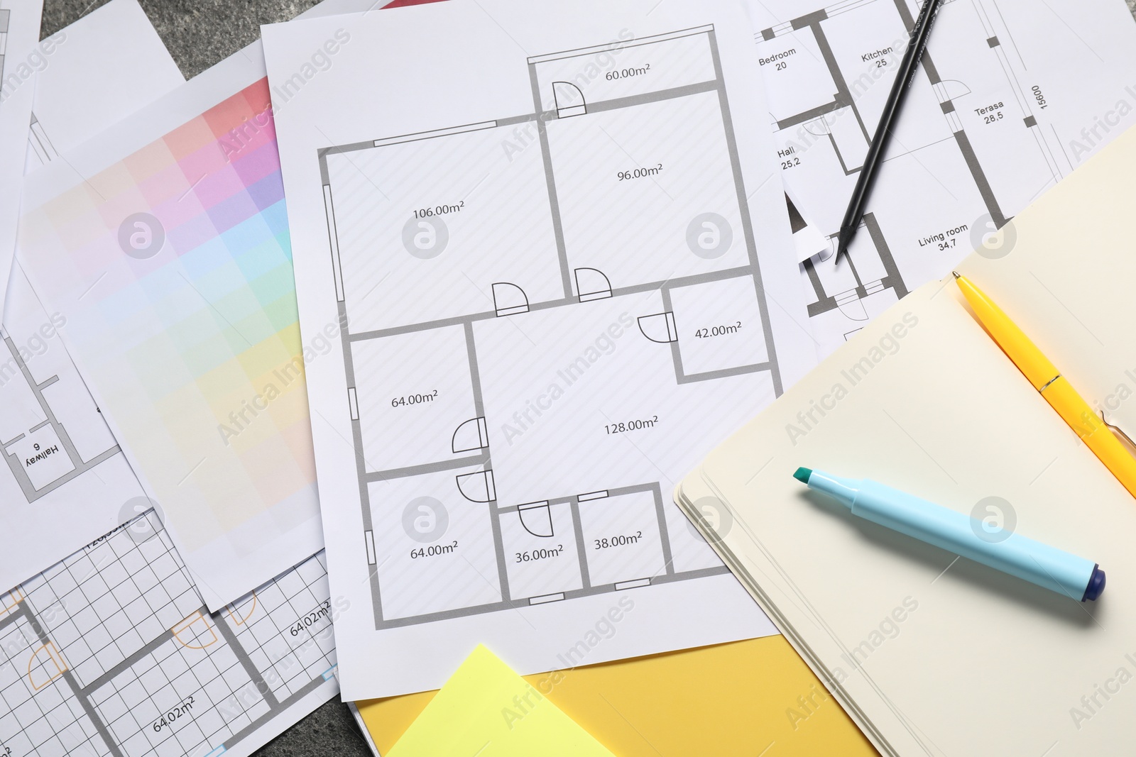 Photo of Designer's workplace with house plans, color palette and stationery on table, flat lay