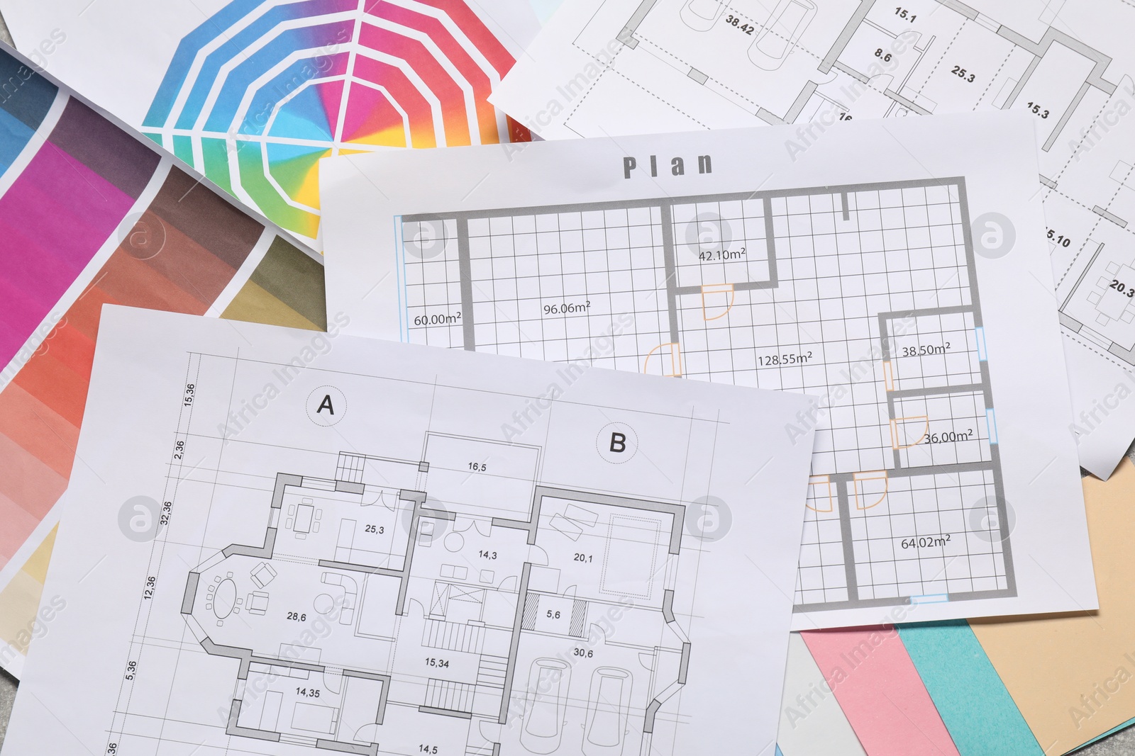 Photo of Designer's workplace with house plans and color palettes on table, top view