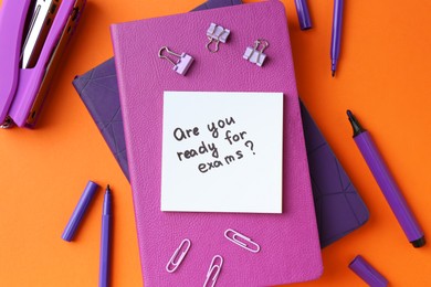 Paper note with question Are You Ready For Exams and stationery on orange background, flat lay