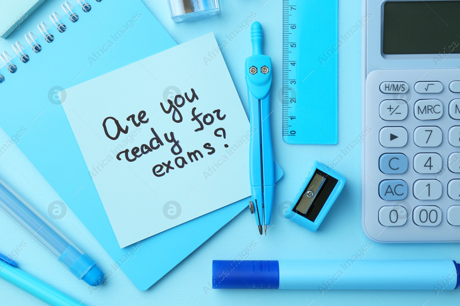 Photo of Paper note with question Are You Ready For Exam and stationery on light blue background, flat lay