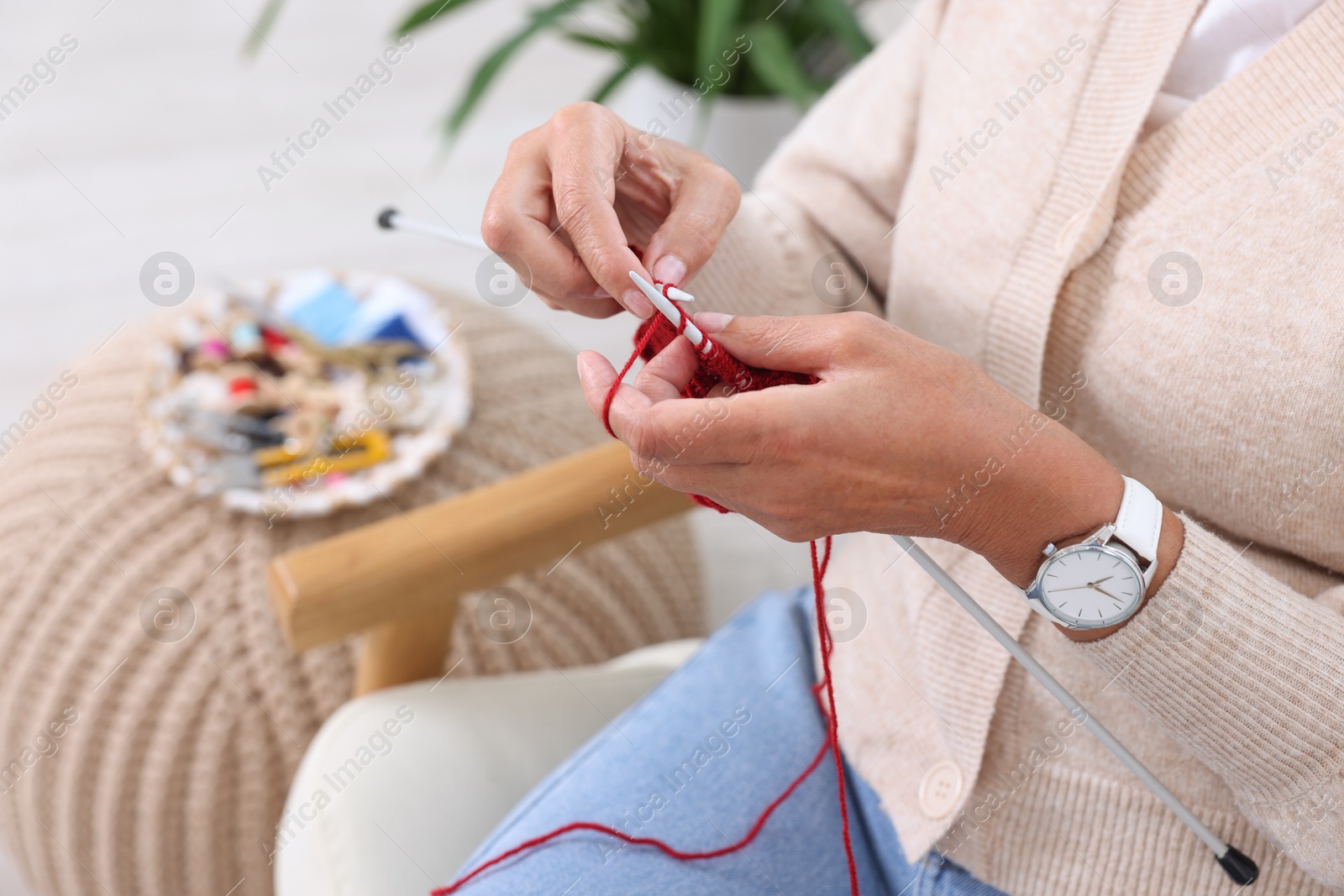 Photo of Woman knitting at home, closeup. Handicraft hobby