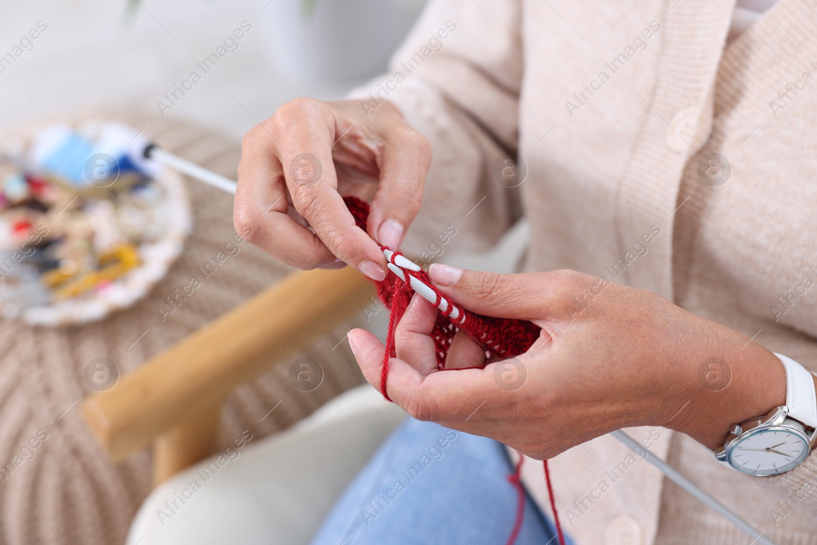 Photo of Woman knitting at home, closeup. Handicraft hobby