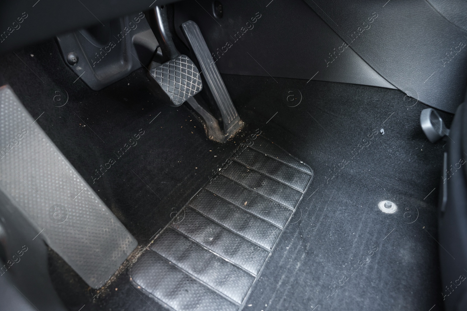 Photo of Black soft car floor mat in auto