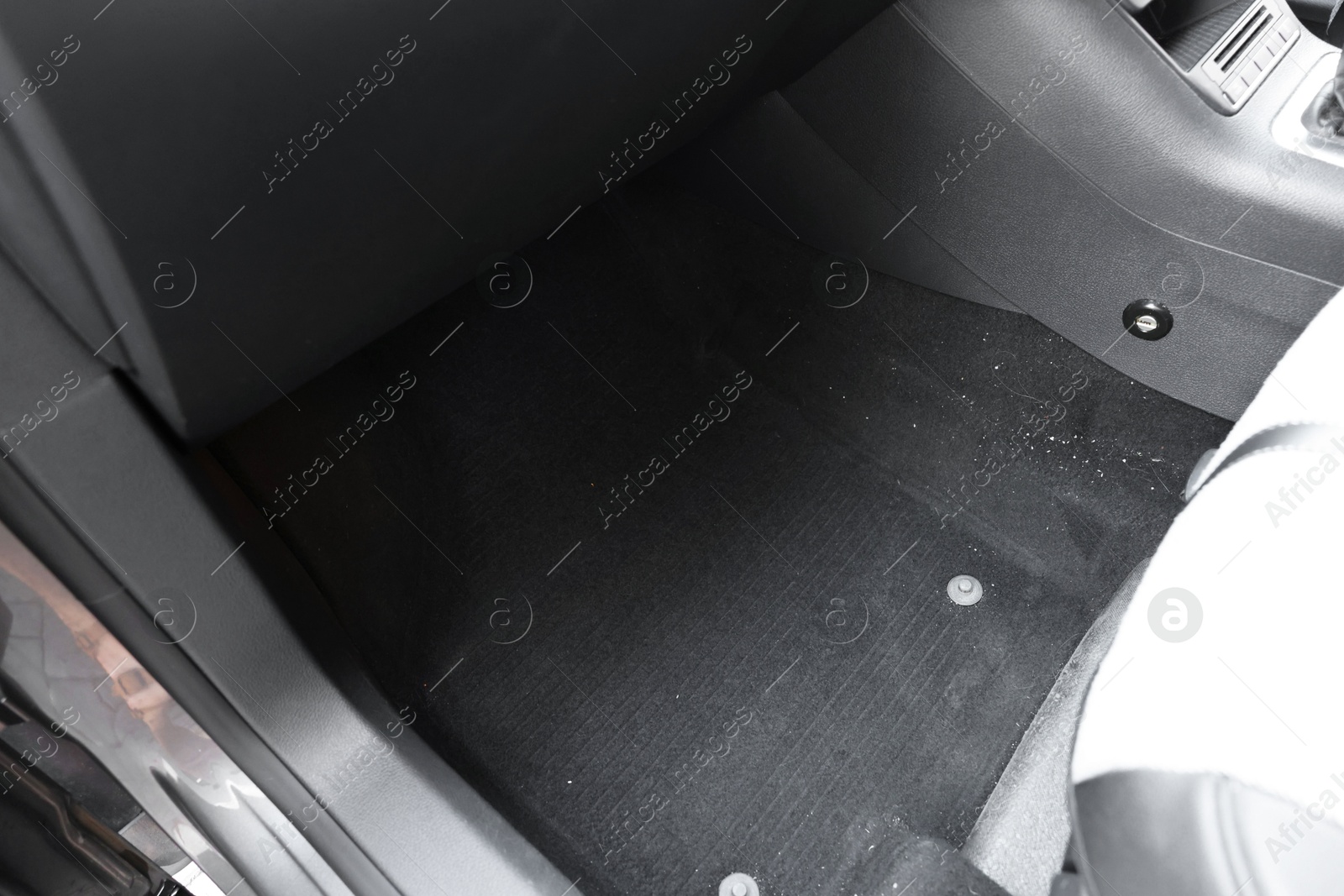 Photo of Black soft car floor mat in auto