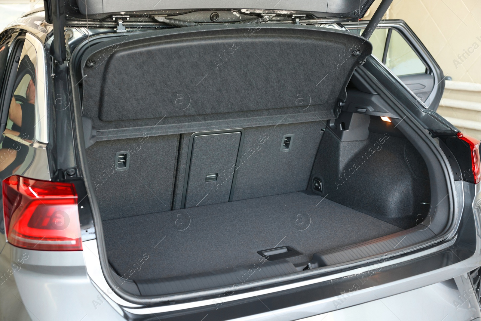 Photo of Grey soft car boot liner mat in trunk of auto