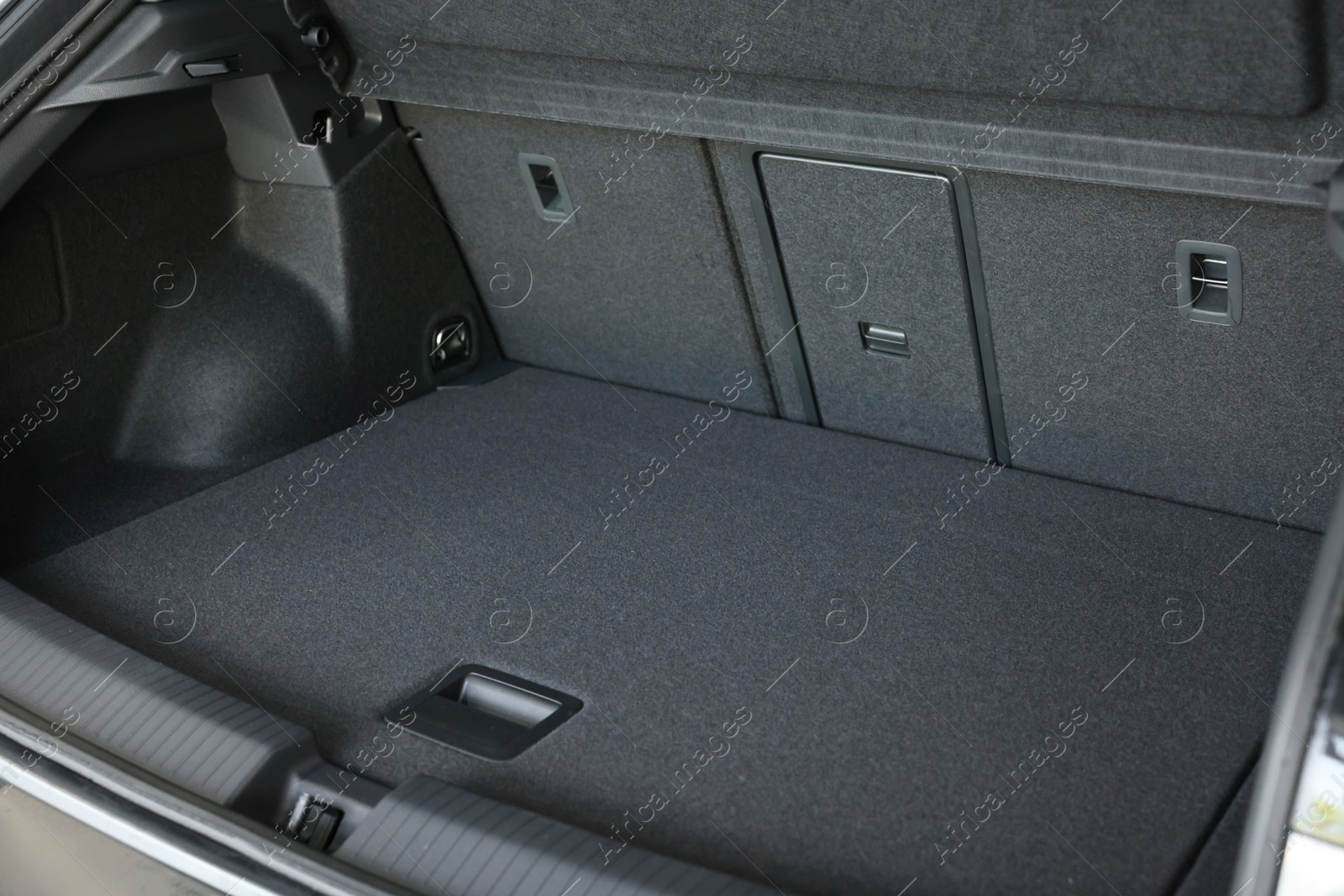 Photo of Grey soft car boot liner mat in trunk of auto