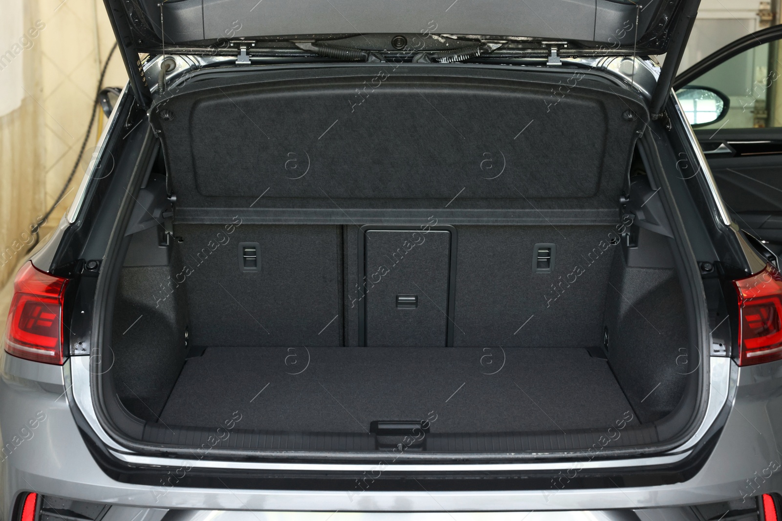 Photo of Grey soft car boot liner mat in trunk of auto