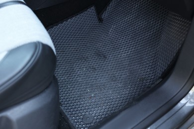 Photo of Dirty grey rubber car mat in auto