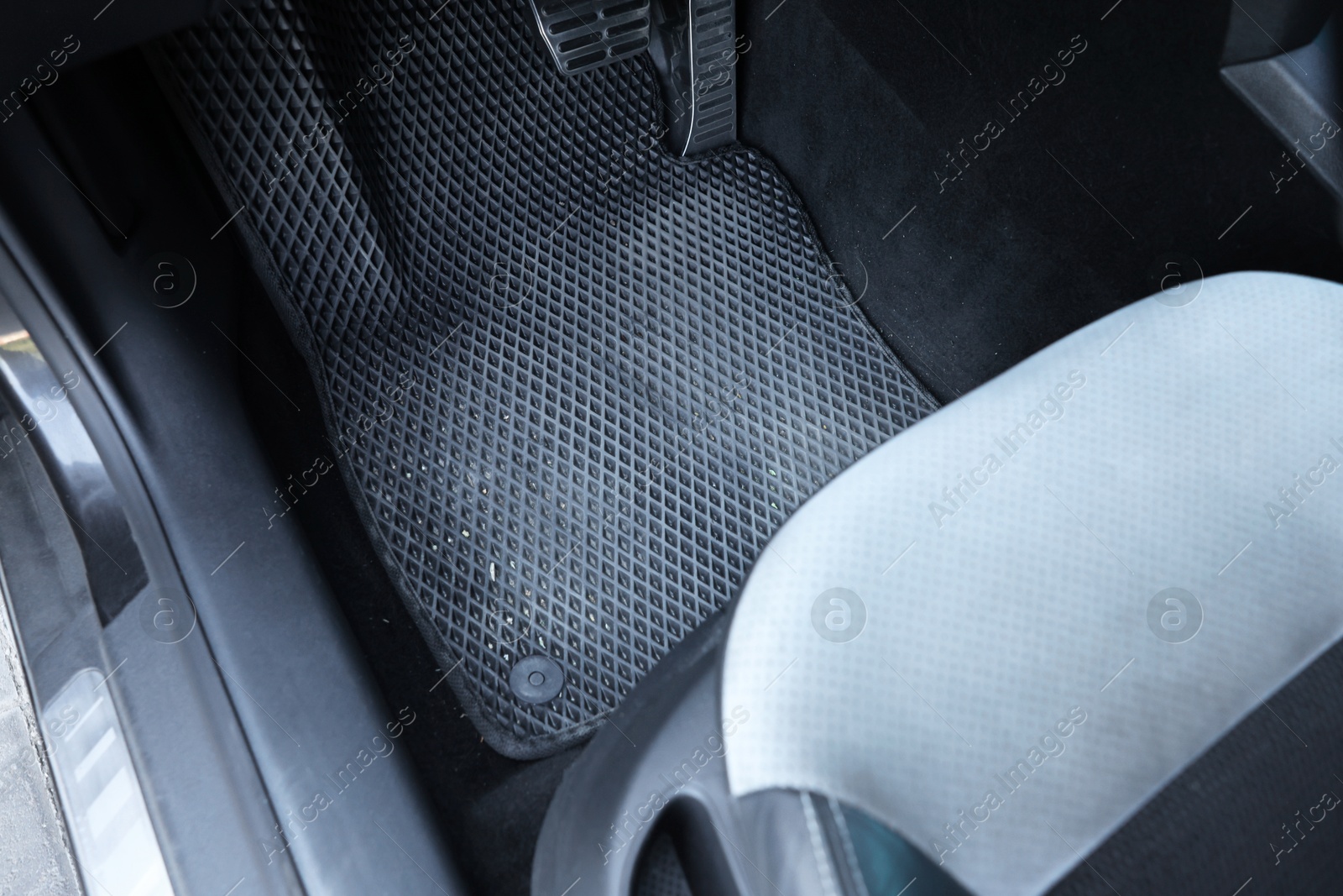 Photo of Dirty grey rubber car mat in auto