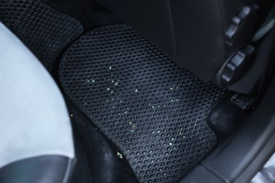 Photo of Dirty black rubber car mat in auto