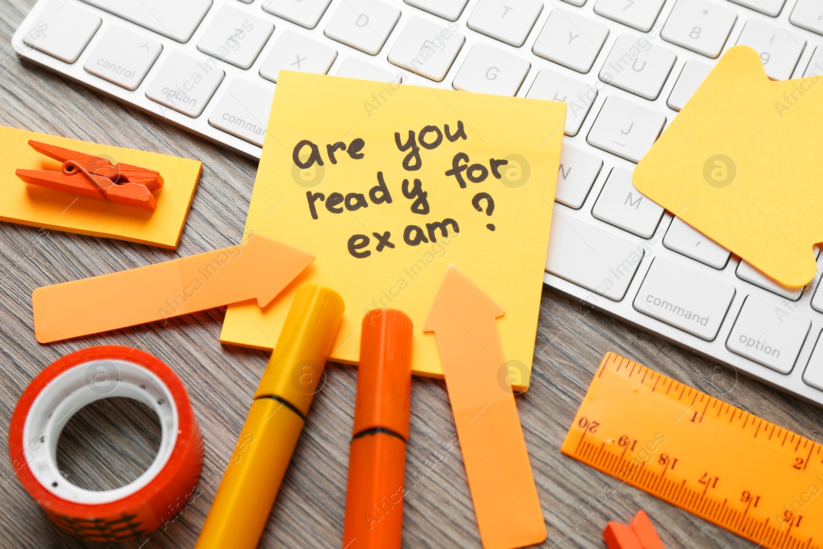 Photo of Note with question Are You Ready For Exam and stationery on wooden desk, closeup