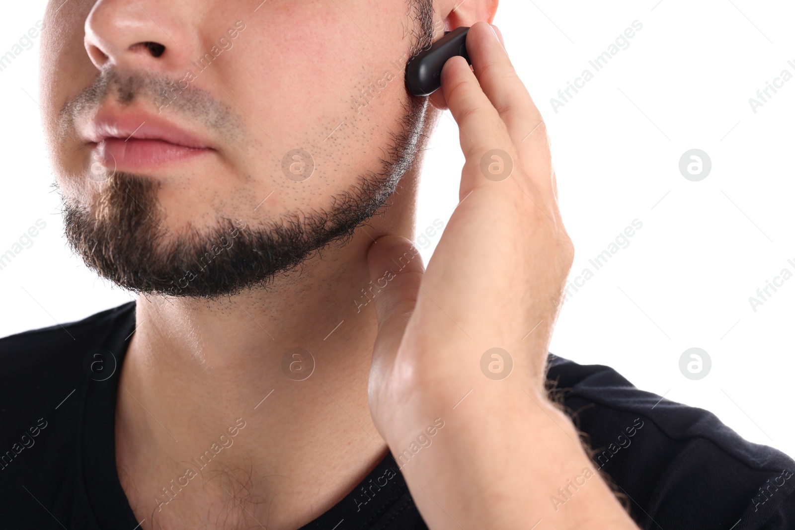 Photo of Young bodyguard with earpiece isolated on white, closeup