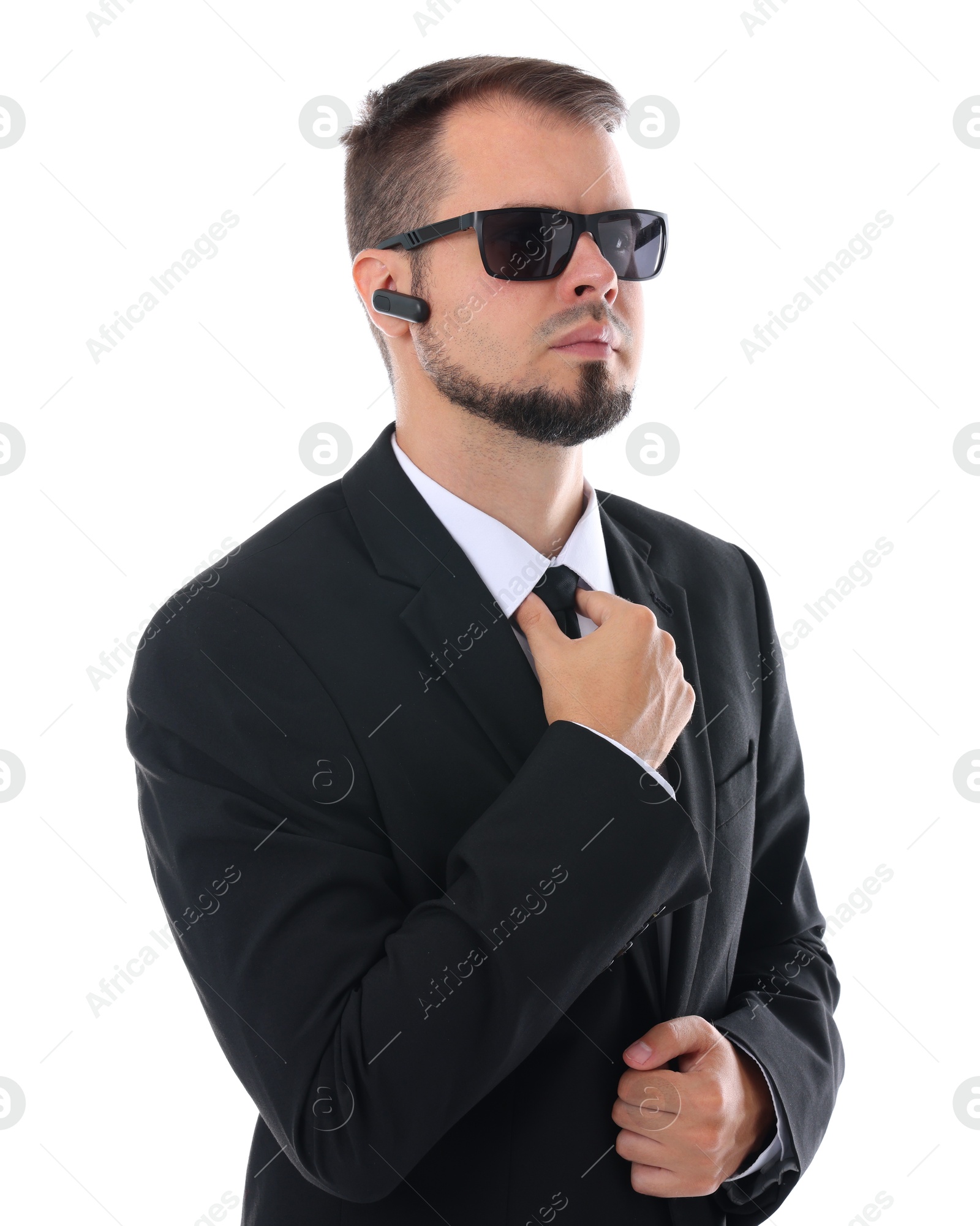 Photo of Young bodyguard in suit and sunglasses isolated on white