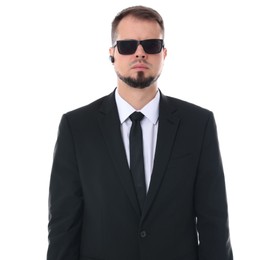 Photo of Young bodyguard in suit and sunglasses isolated on white