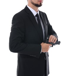 Photo of Young bodyguard in suit with gun isolated on white, closeup