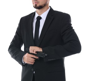 Photo of Young bodyguard in suit with gun isolated on white, closeup