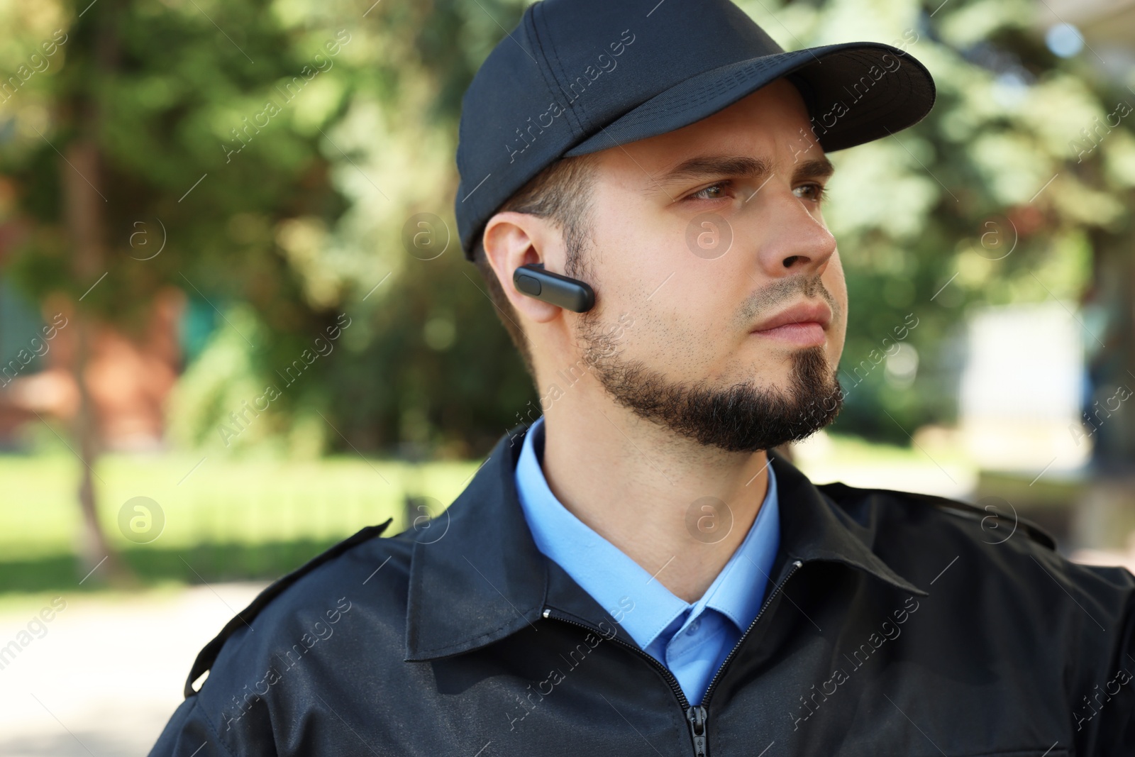 Photo of Security guard in uniform with earpiece outdoors