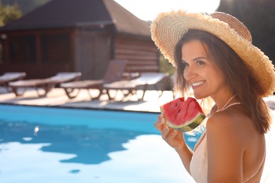 Photo of Happy woman with slice of juicy watermelon near swimming pool outdoors, space for text