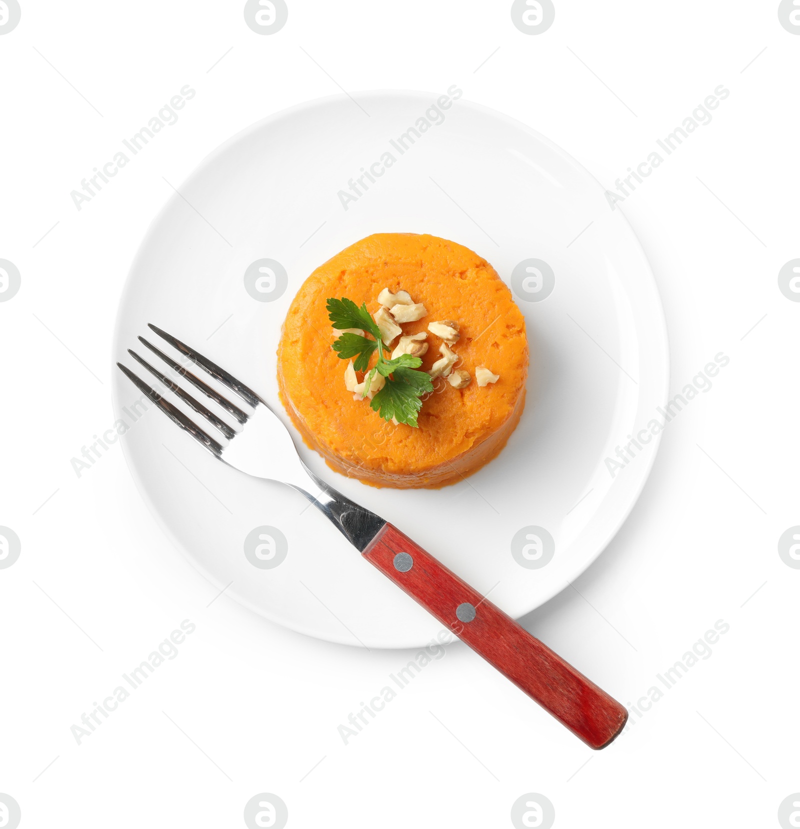 Photo of Plate with tasty mashed sweet potato, parsley and walnuts isolated on white, top view