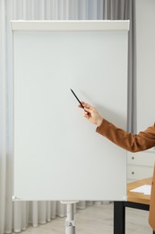 Woman near flip chart in office, closeup. Mockup for design