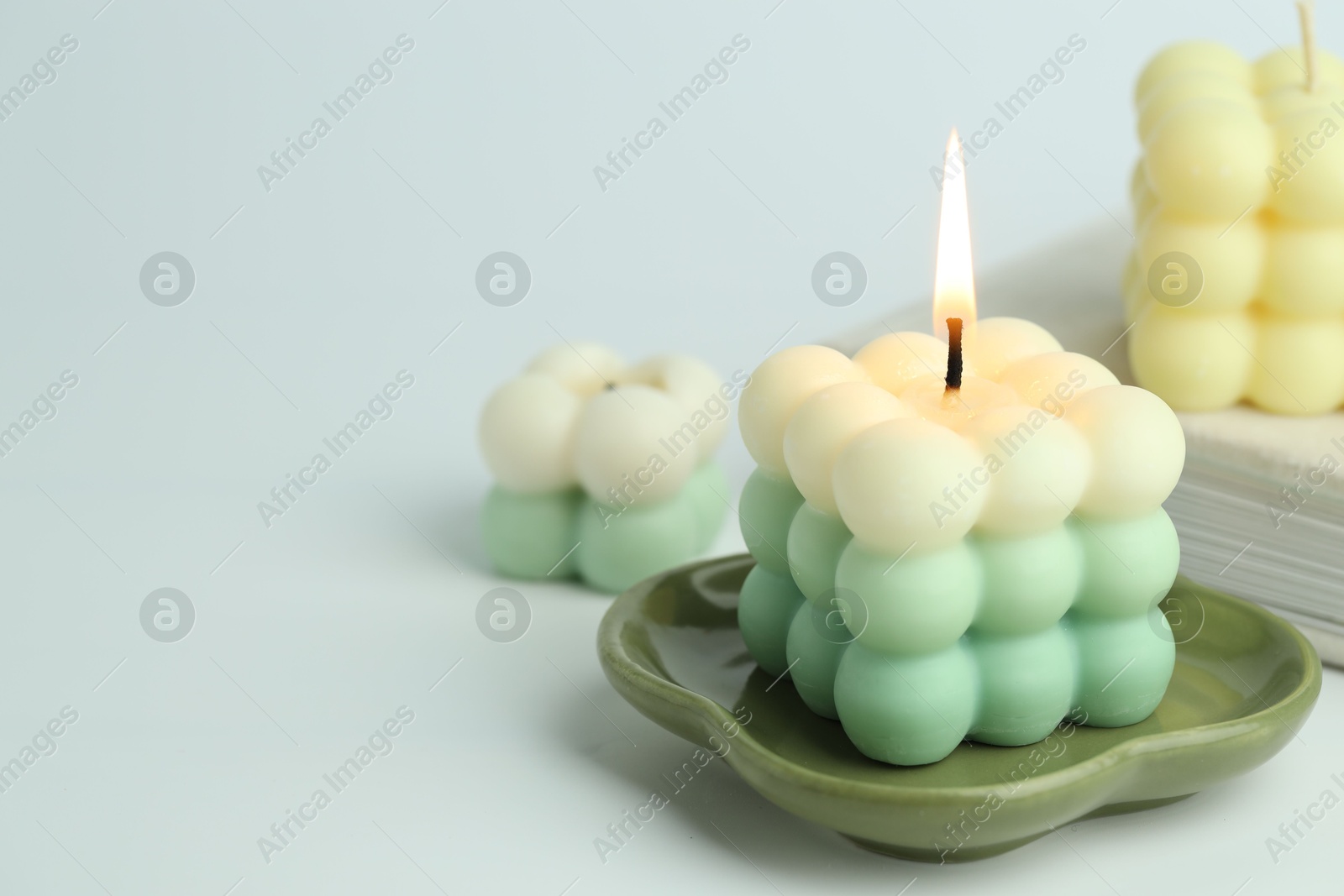 Photo of Beautiful bubble candles on light background, closeup. Space for text