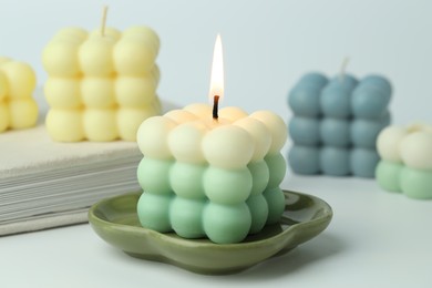 Photo of Beautiful bubble candles on light background, closeup