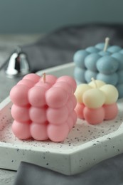 Photo of Three beautiful bubble candles on table, closeup