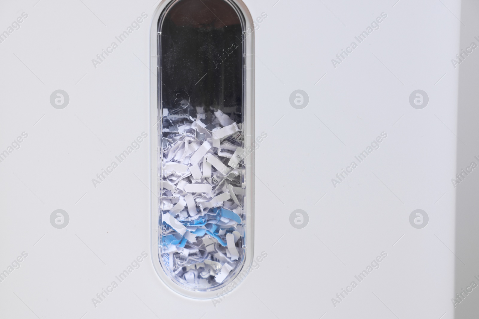 Photo of Closeup view of shredder with paper strips