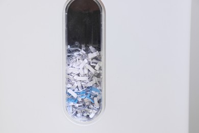 Closeup view of shredder with paper strips