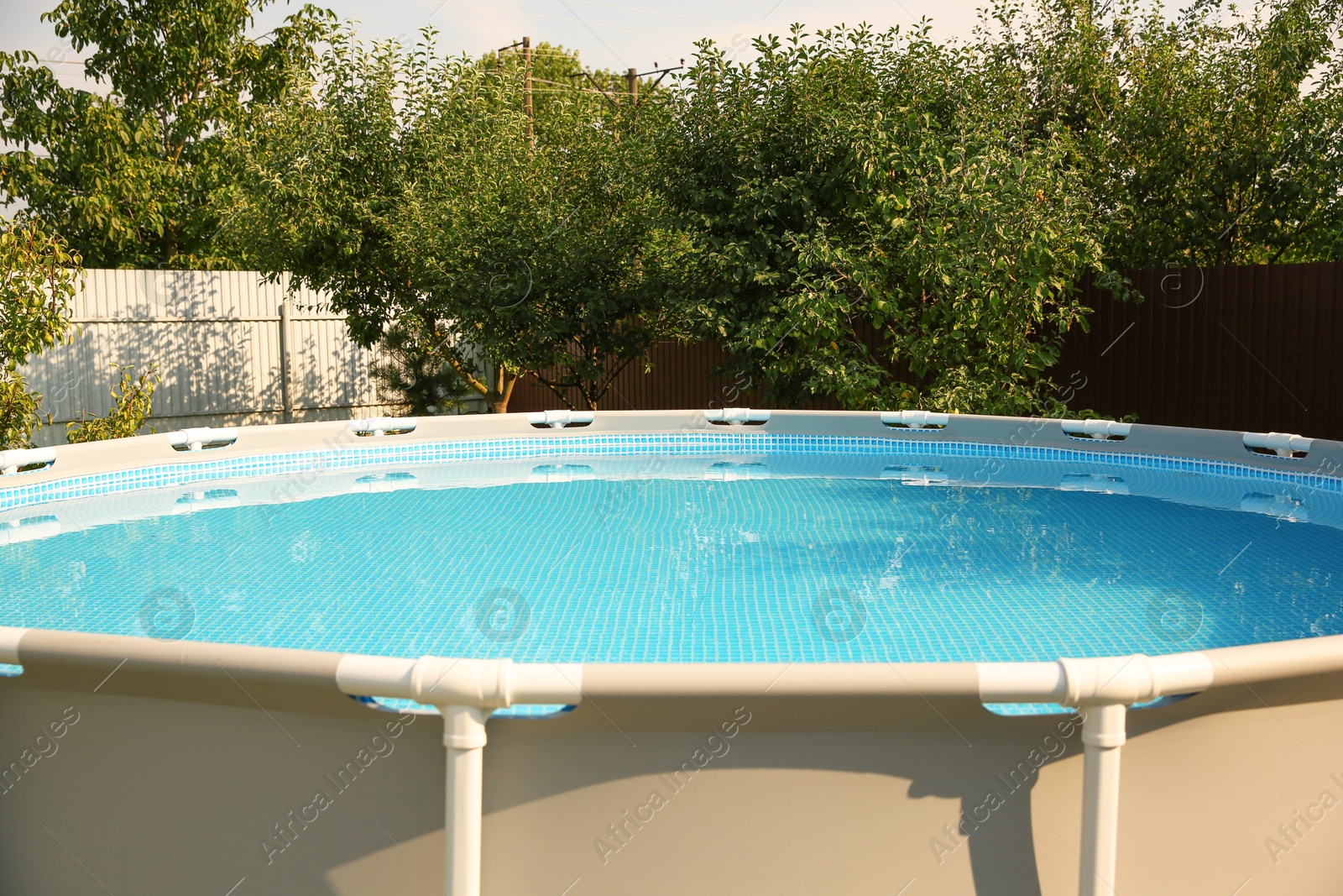 Photo of Above ground swimming pool outdoors on sunny day