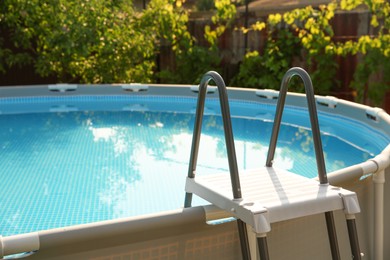 Photo of Above ground swimming pool outdoors on sunny day