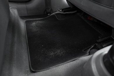 Photo of Black soft car floor mat in auto