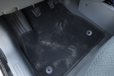 Photo of Black soft car floor mat in auto