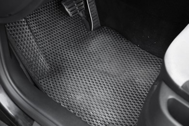 Photo of Grey rubber car floor mat in auto