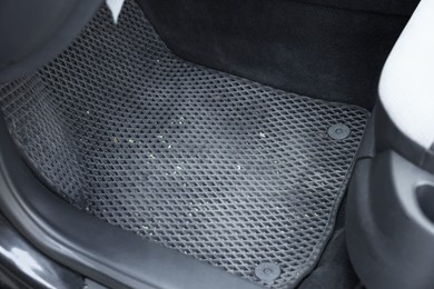 Photo of Grey rubber car floor mat in auto