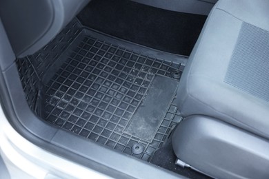 Photo of Black rubber car floor mat in auto