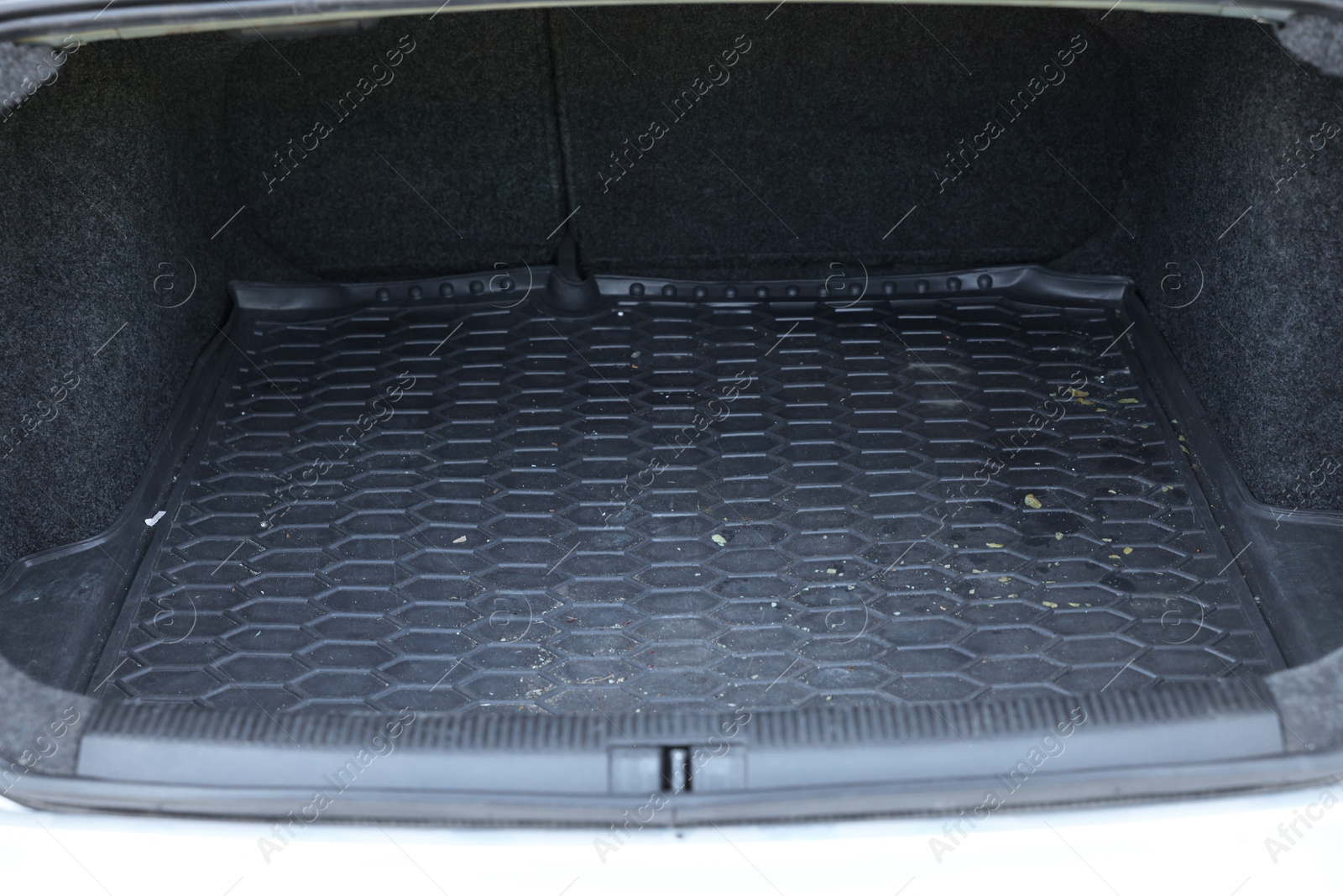 Photo of Black rubber car boot liner mat in trunk of auto