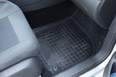 Photo of Black rubber car floor mat in auto