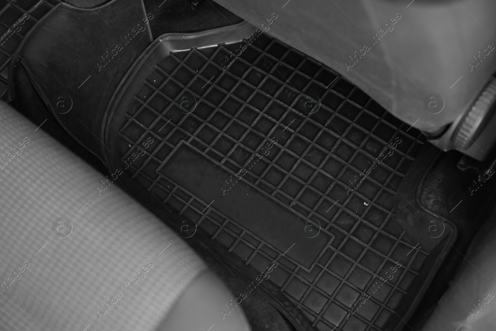 Photo of Black rubber car floor mat in auto