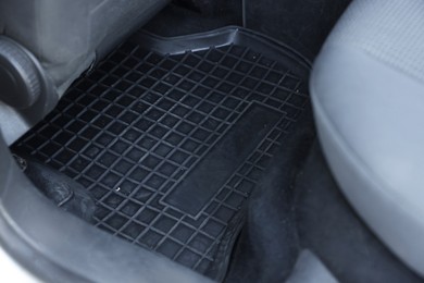 Photo of Black rubber car floor mat in auto