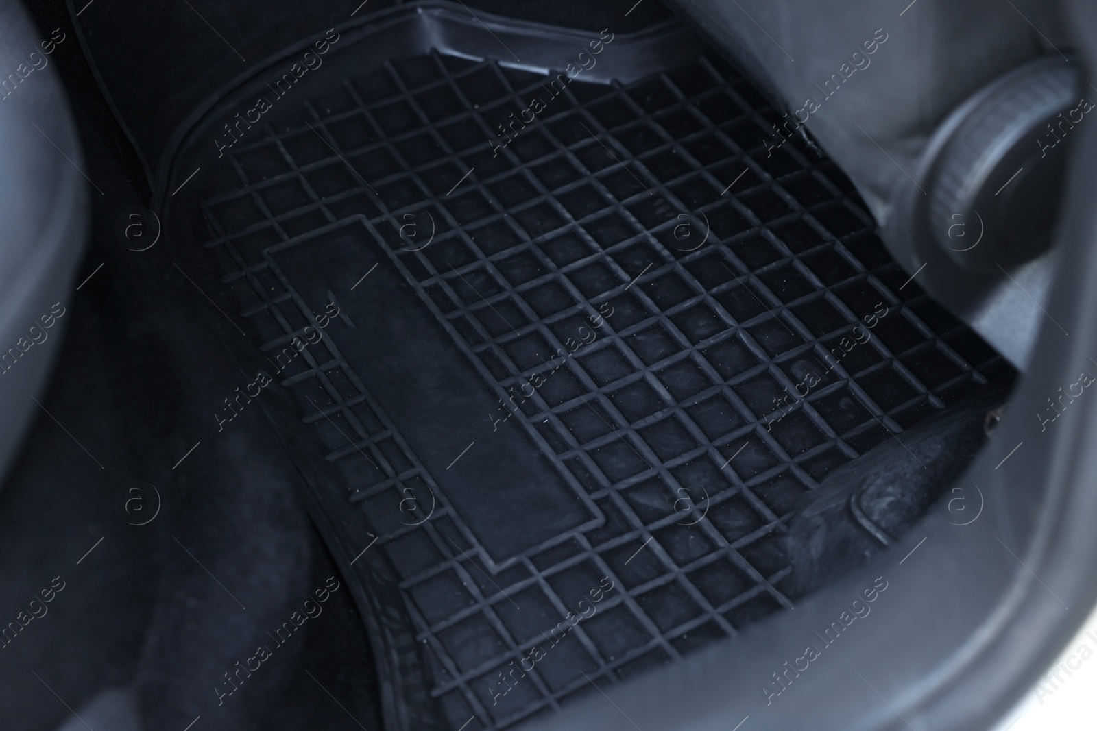 Photo of Black rubber car floor mat in auto