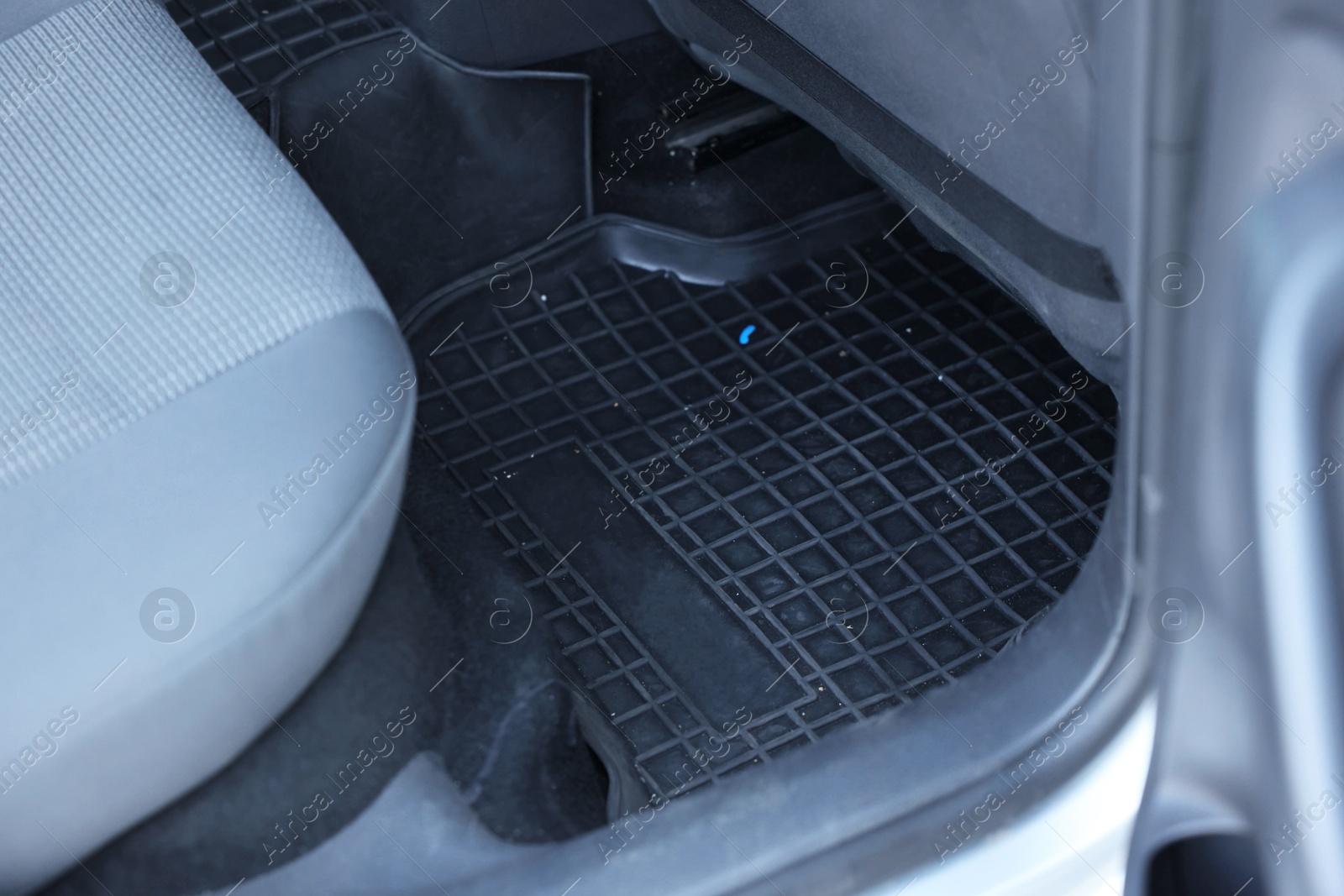 Photo of Black rubber car floor mat in auto