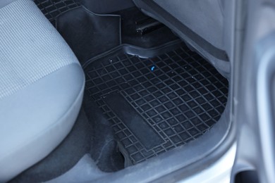 Photo of Black rubber car floor mat in auto