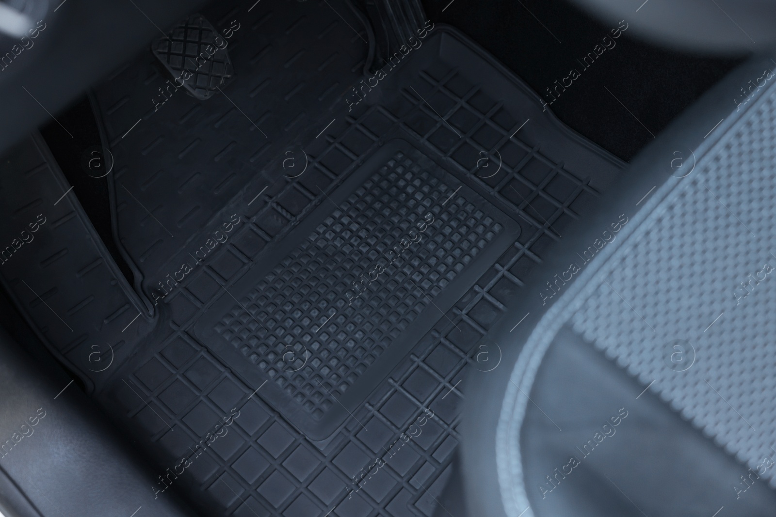 Photo of Black rubber car floor mat in auto