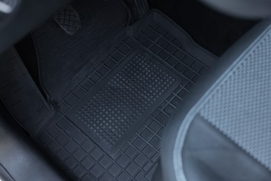 Photo of Black rubber car floor mat in auto